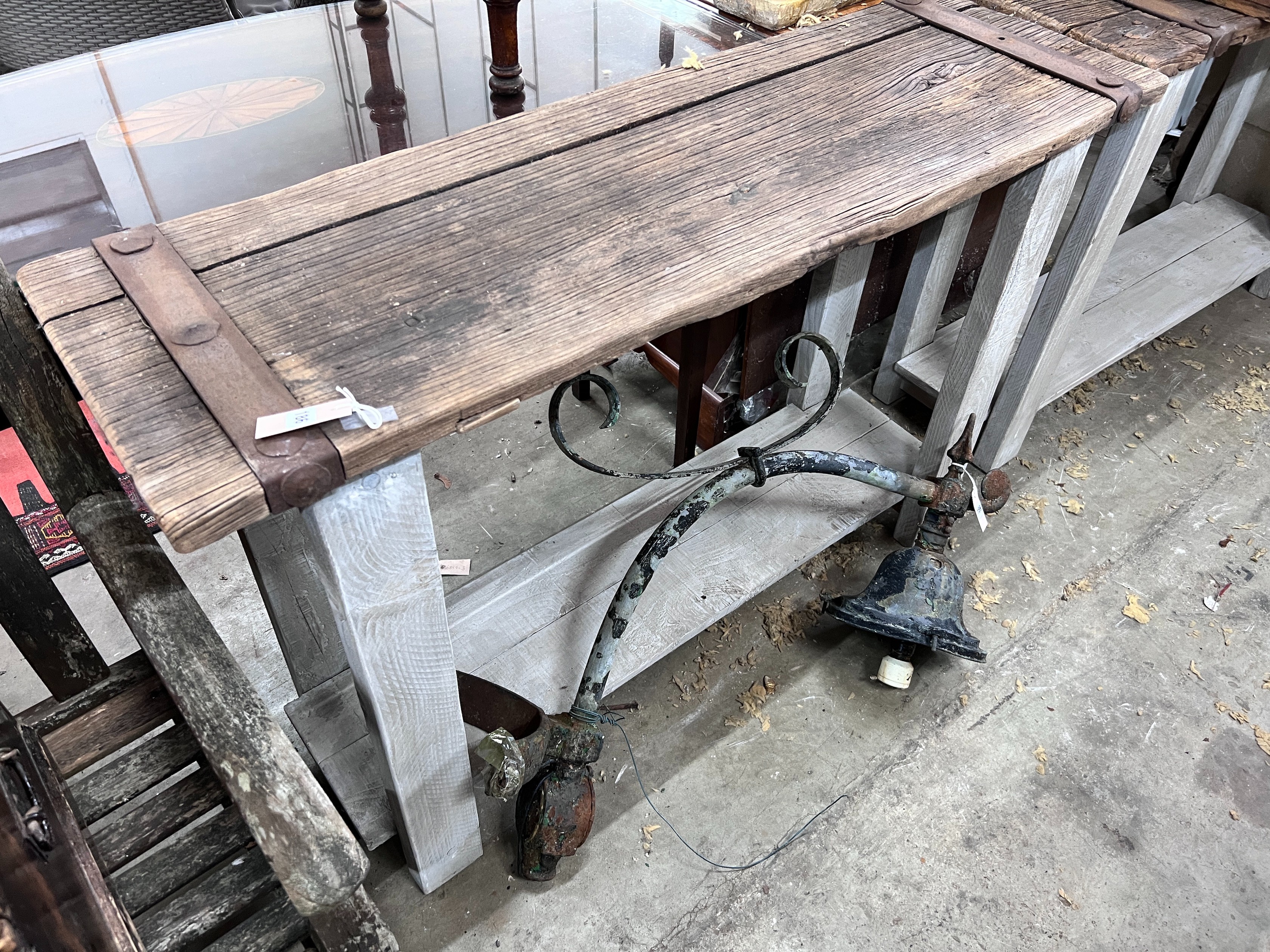 A pair of stained oak console tables with iron bound raw wood tops, width 132cm, depth 40cm, height 87cm *Please note the sale commences at 9am.